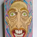 Wild-eyed character artwork painted on wood
